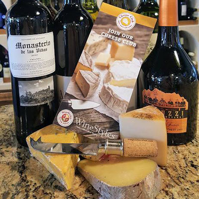 Cheese Club brochure with cheese and wine bottles